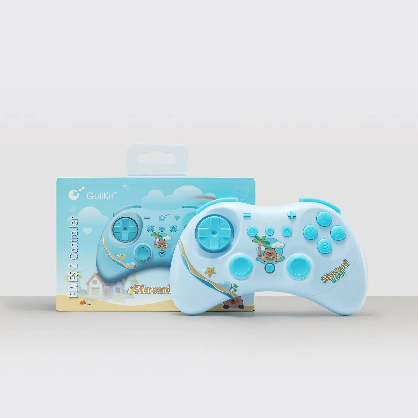 水色のゲームコントローラーと箱の画像です。コントローラーには、十字キー、A、B、X、Yボタン、アナログスティック、その他のボタンが付いています。箱にはコントローラーのグラフィックとGuliKitのロゴが描かれています。